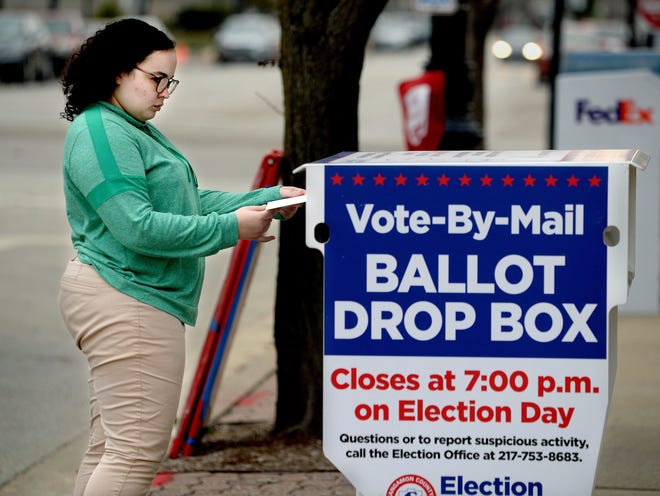 Drew Cloud puts her ballot in the dropbox on Monroe Street next to the Sangamon County Complex Tuesday Nov. 8, 2022.